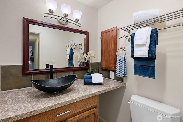 half bathroom with toilet and vanity