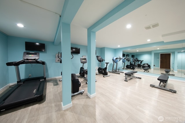 exercise room featuring wood finished floors, baseboards, and recessed lighting
