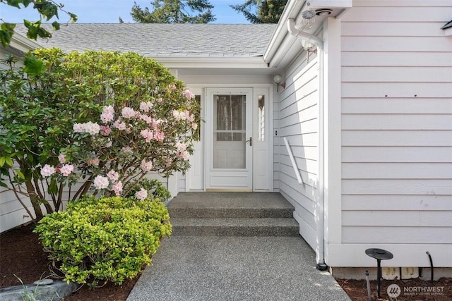 property entrance with a shingled roof