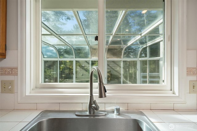 interior details with tile counters and a sink