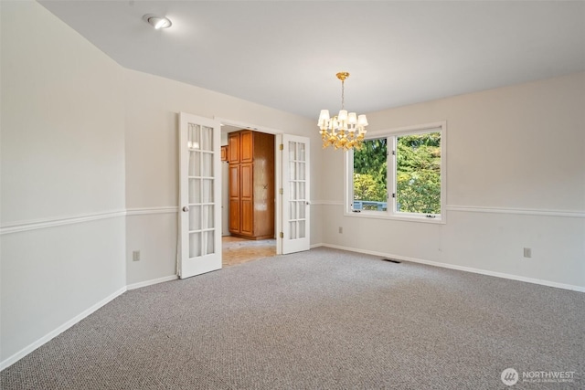 unfurnished room featuring french doors, visible vents, an inviting chandelier, light carpet, and baseboards