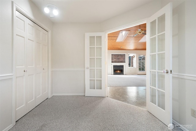 interior space featuring french doors and a lit fireplace