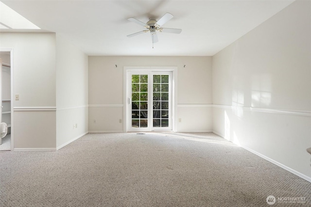 unfurnished room featuring carpet flooring, baseboards, and a ceiling fan