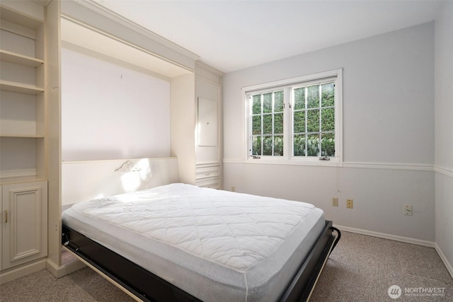 bedroom featuring carpet and baseboards