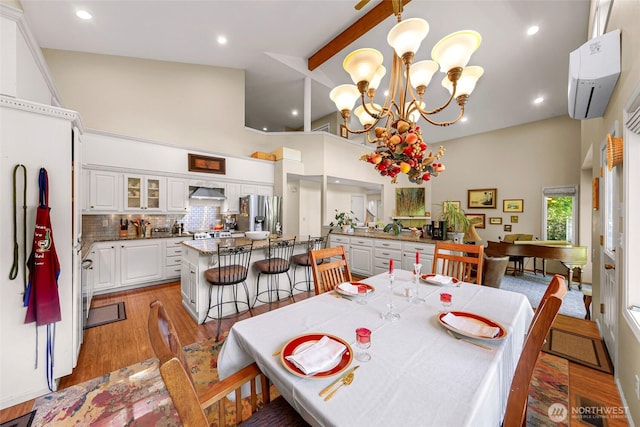 6874 Golf View Dr, Lynden, WA 98264 - dining room with an AC wall unit, high vaulted ceiling, light wood-style flooring, a chandelier, and beam ceiling