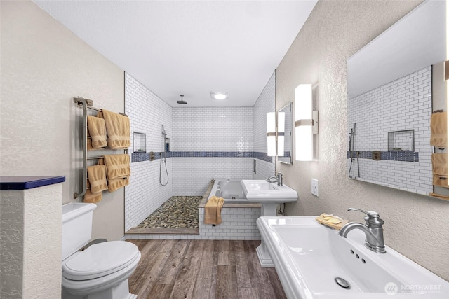 6874 Golf View Dr, Lynden, WA 98264 - bathroom with a sink, toilet, a textured wall, wood finished floors, and walk in shower