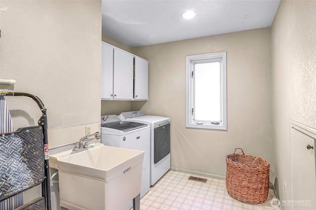 6874 Golf View Dr, Lynden, WA 98264 - laundry area featuring washer and dryer, light flooring, cabinet space, and baseboards