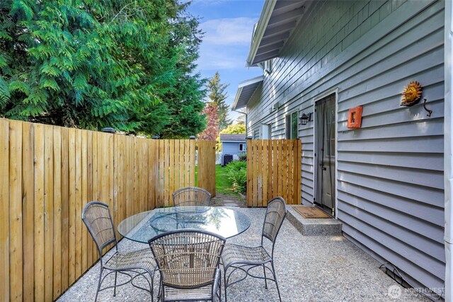 6874 Golf View Dr, Lynden, WA 98264 - view of patio with fence and outdoor dining area