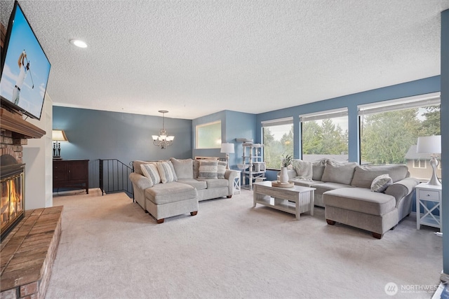 living room featuring a textured ceiling, light colored carpet, a chandelier, and a brick fireplace