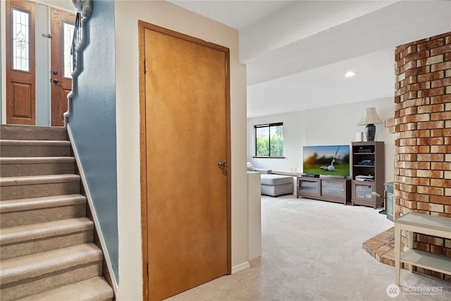 staircase featuring carpet floors