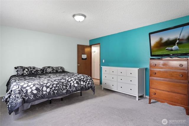 bedroom featuring carpet floors and a textured ceiling