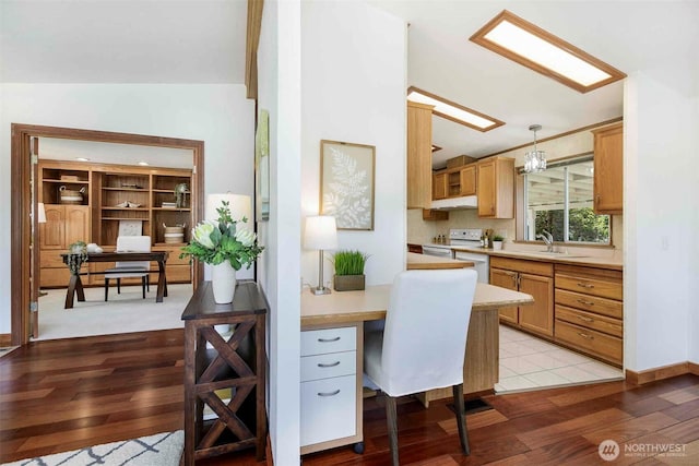 home office featuring light wood-style floors and a sink