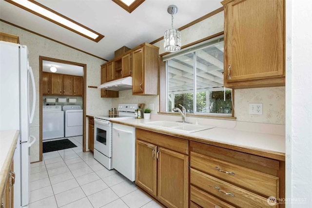 kitchen with white appliances, separate washer and dryer, a sink, lofted ceiling, and under cabinet range hood