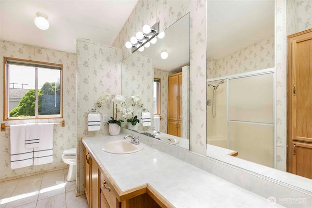 bathroom featuring wallpapered walls, a shower with door, tile patterned flooring, toilet, and vanity