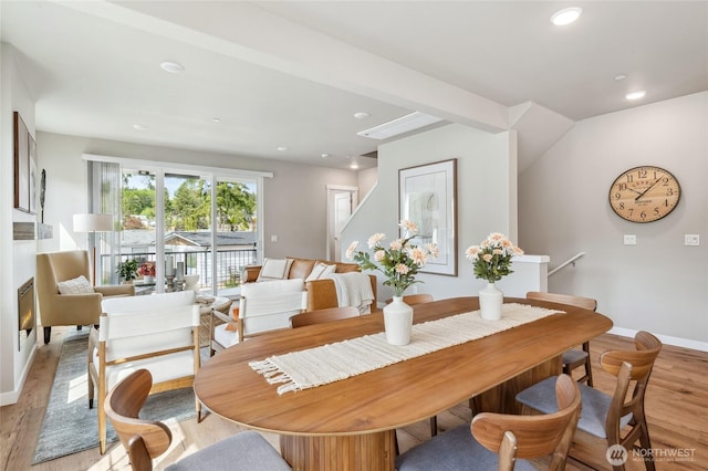 dining area with baseboards, light wood-style flooring, and recessed lighting