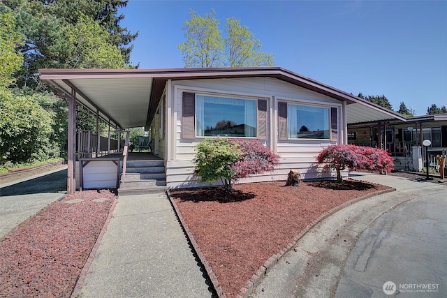 manufactured / mobile home with covered porch and an attached carport