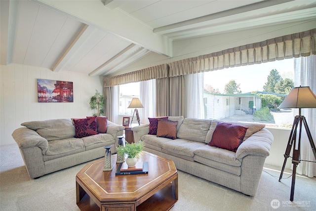 carpeted living room with vaulted ceiling with beams