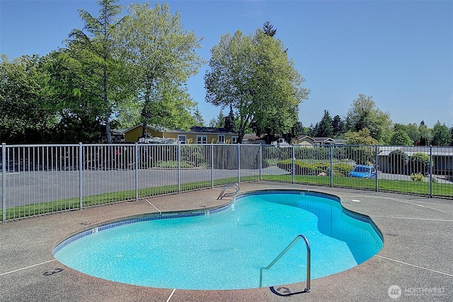 view of swimming pool with a patio, a fenced in pool, and fence