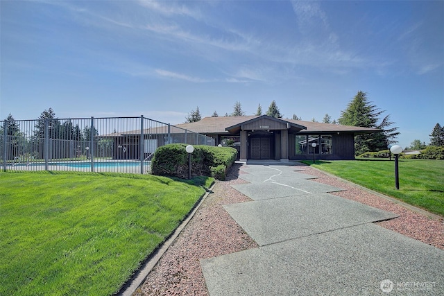 ranch-style home featuring fence, a fenced in pool, and a front yard