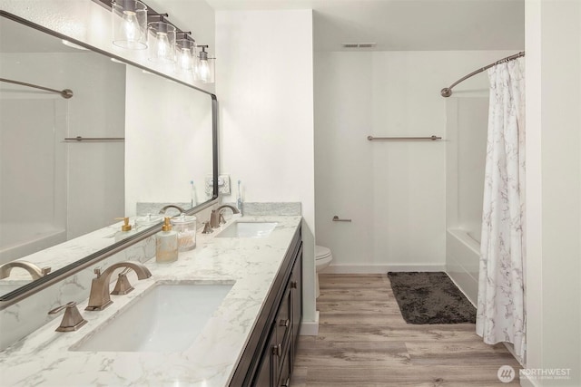 29058 215th Pl SE, Kent, WA 98042 - full bath with wood finished floors, shower / tub combo, toilet, double vanity, and baseboards