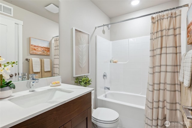 bathroom featuring shower / bath combo with shower curtain, toilet, visible vents, and vanity