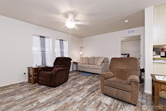 living room with ceiling fan and wood finished floors