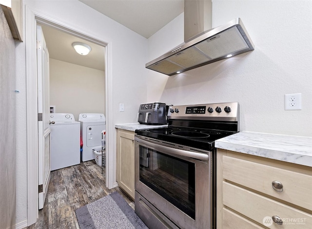 kitchen featuring stainless steel electric stove, separate washer and dryer, range hood, light countertops, and dark wood finished floors