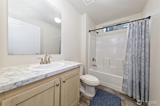 full bath with wood finished floors, toilet, vanity, and shower / bath combo with shower curtain