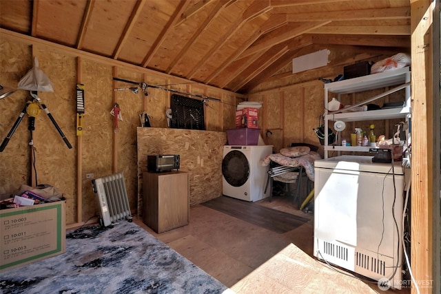 storage room with washer / clothes dryer and radiator