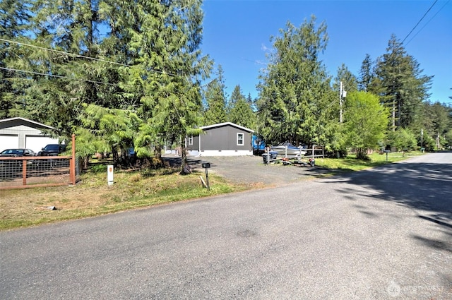 view of front facade featuring view of scattered trees