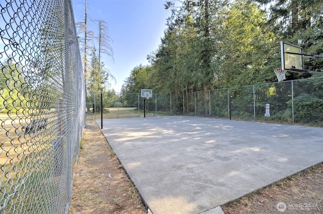 view of basketball court with community basketball court and fence