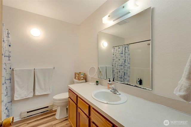bathroom featuring a baseboard heating unit, wood finished floors, vanity, toilet, and curtained shower