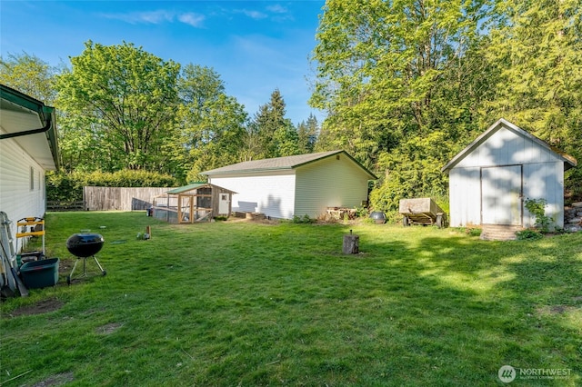 view of yard featuring an outdoor structure, exterior structure, and a storage unit