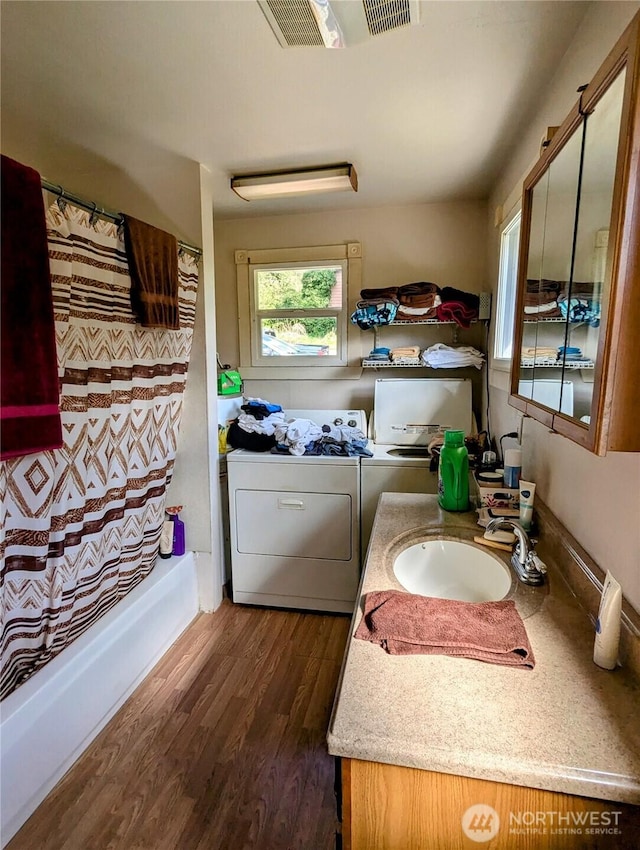 washroom featuring independent washer and dryer and dark wood-type flooring