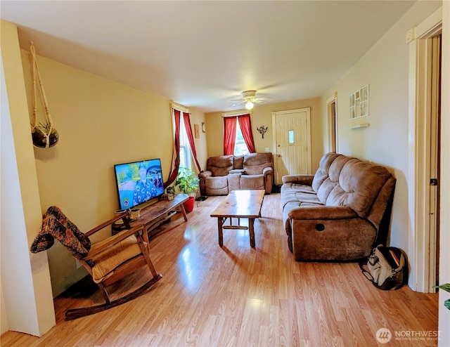 living room with ceiling fan and light wood-type flooring