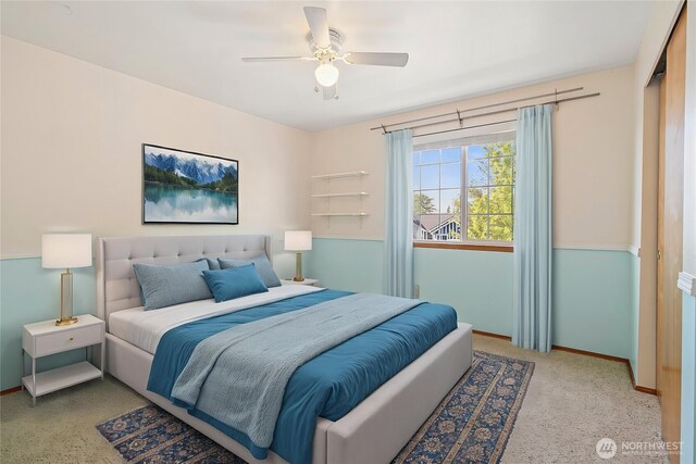 carpeted bedroom featuring baseboards and a ceiling fan