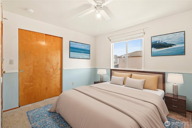 bedroom with carpet floors, a closet, a ceiling fan, and baseboards