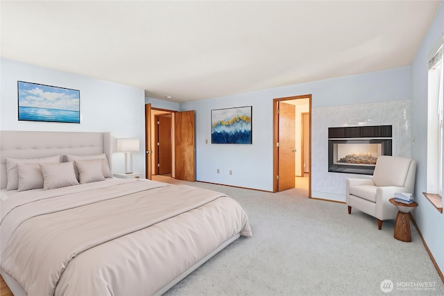 carpeted bedroom with baseboards and a fireplace