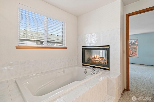 full bath featuring a garden tub and a fireplace