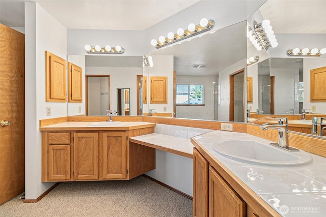 full bathroom with a stall shower, vanity, and baseboards