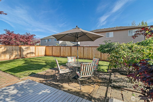wooden deck featuring outdoor dining area and a patio area