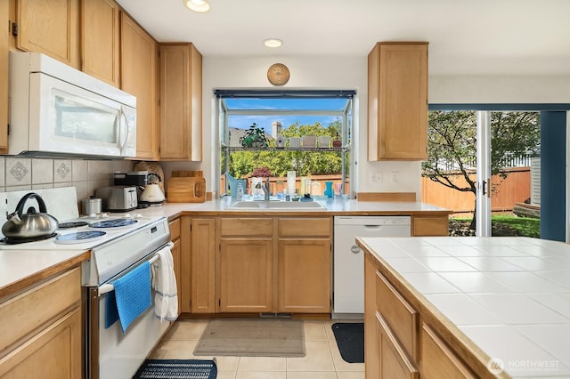 19021 113th Way SE, Renton, WA 98055 - kitchen with white appliances, a sink, tile counters, tasteful backsplash, and light tile patterned flooring