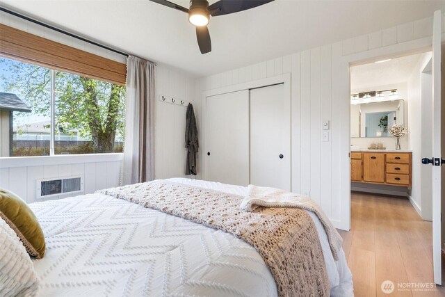 bedroom with light wood finished floors, a closet, and a ceiling fan