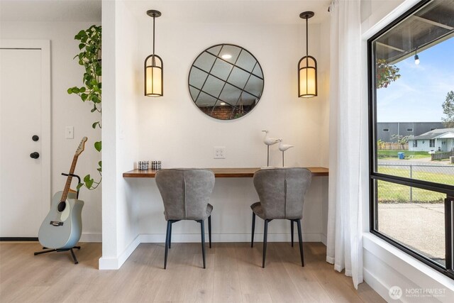 dining room featuring wood finished floors and baseboards