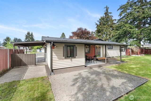 single story home featuring a gate and a patio area