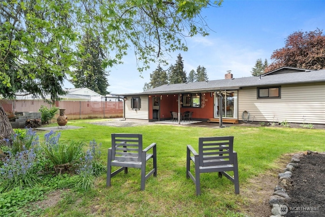 back of property featuring a patio and a chimney
