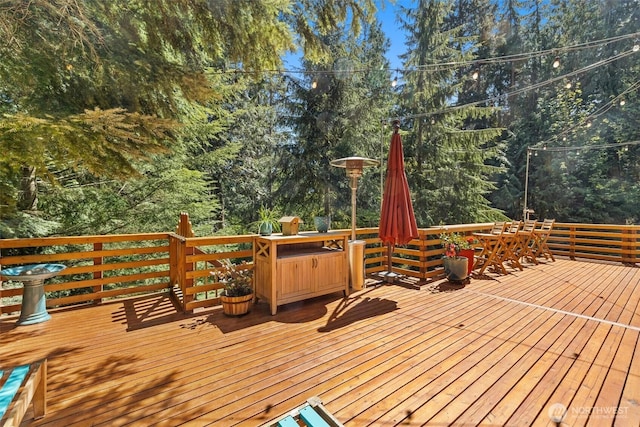 deck featuring view of scattered trees