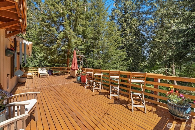 wooden deck with view of wooded area