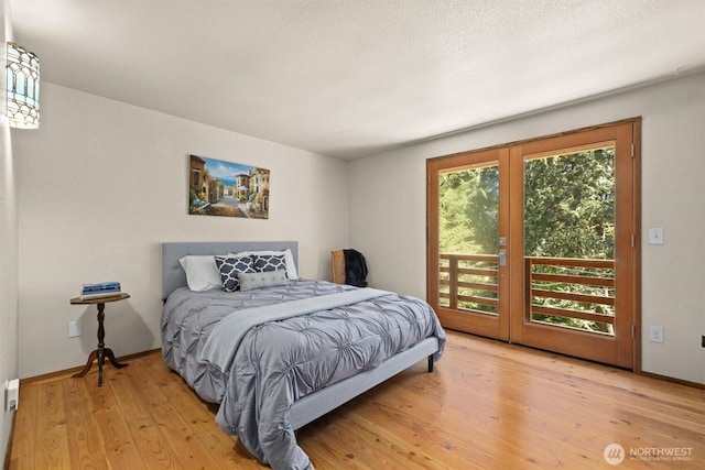 bedroom with light wood-type flooring and baseboards