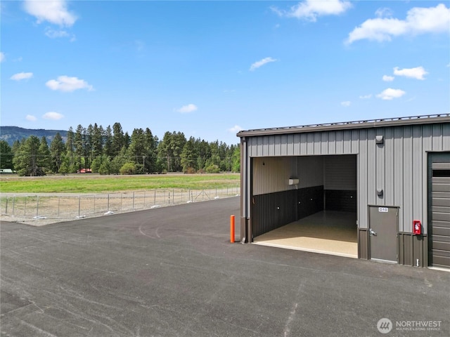garage with a view of trees